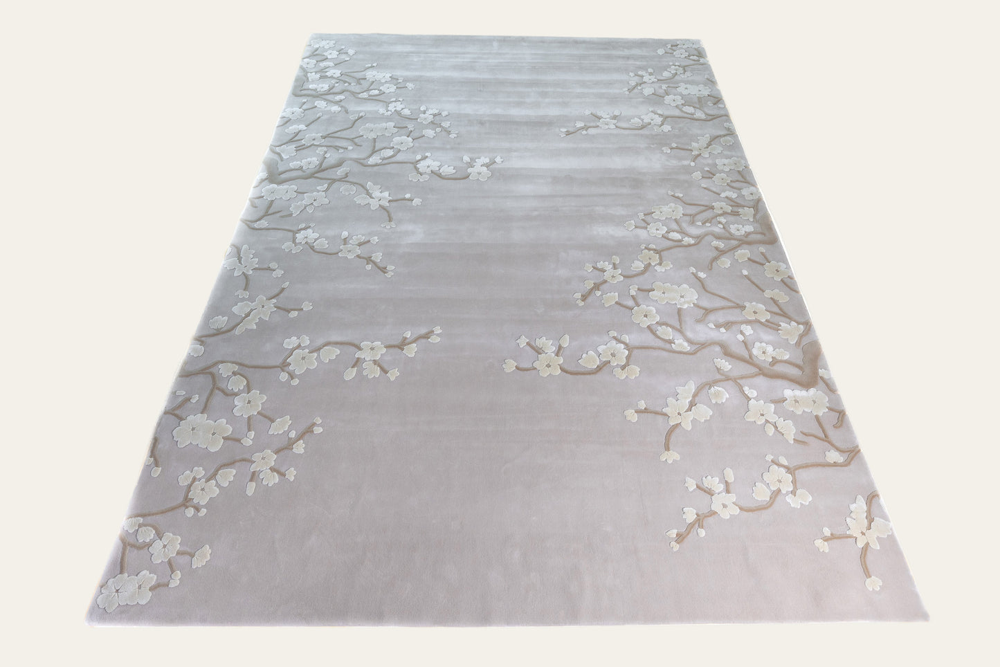 Gray rug with floral patterns on a white background
