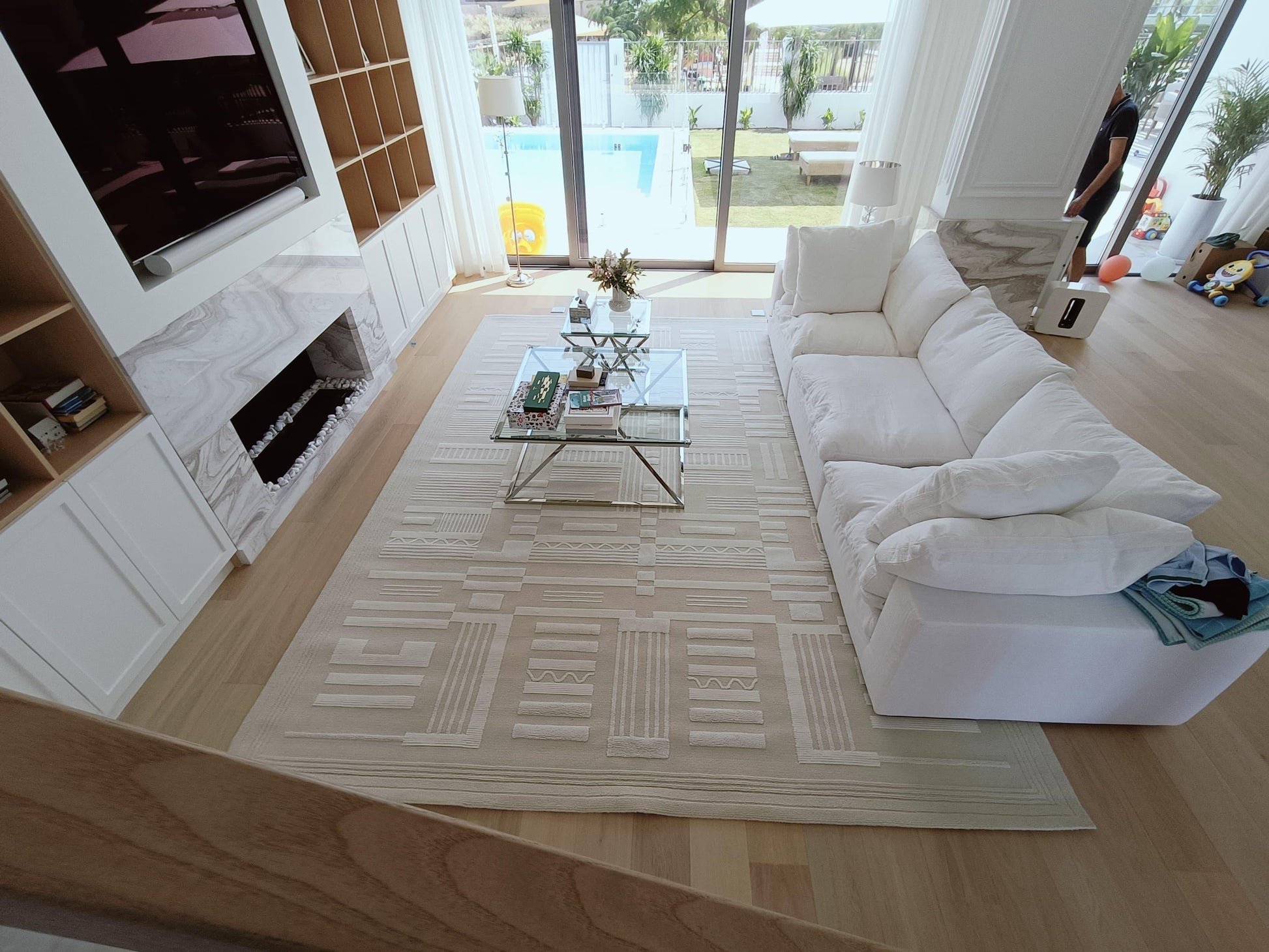 Modern living room with a white sofa, coffee table, and decorative items.