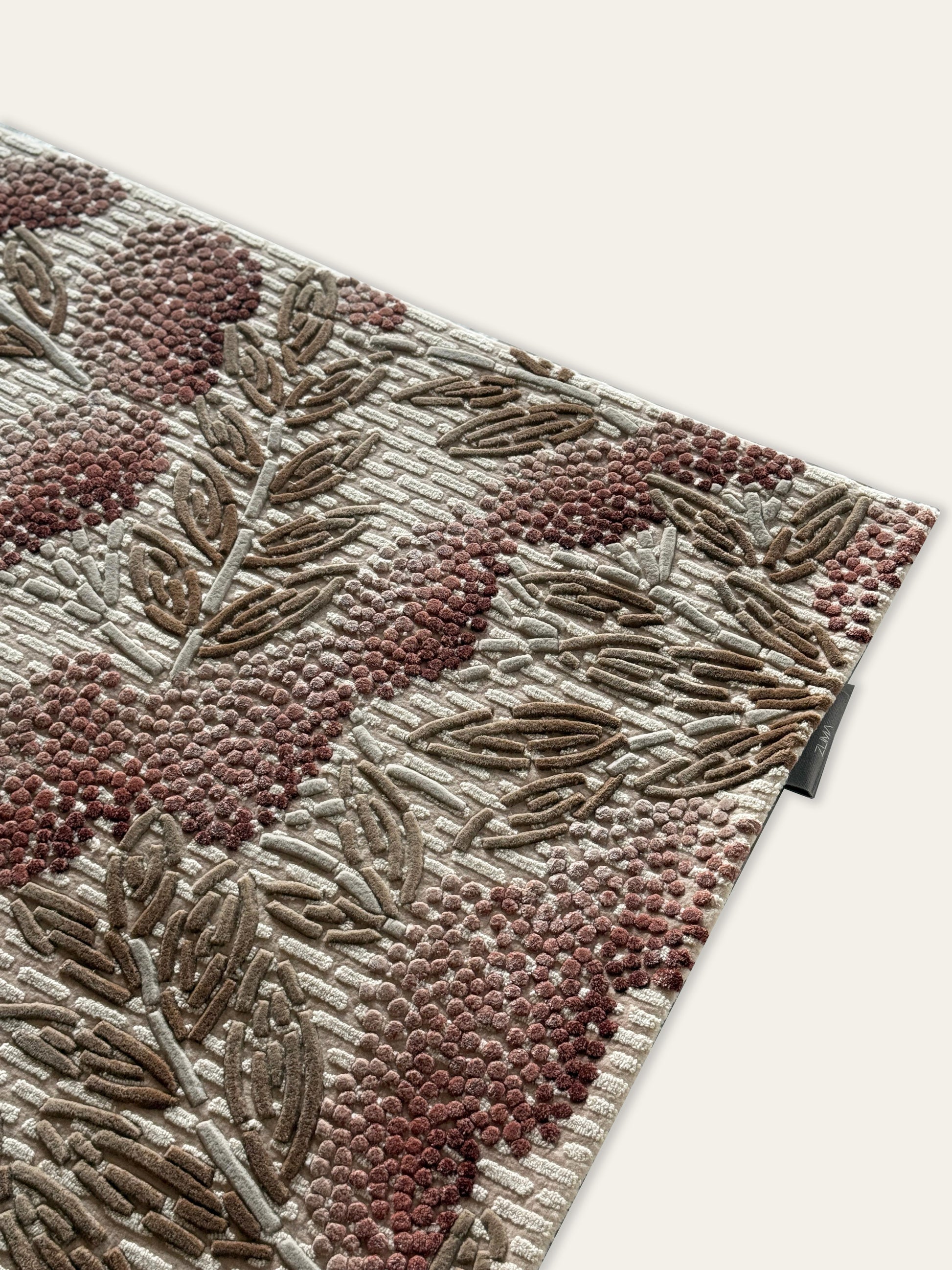 Close-up of a textured rug with floral patterns on a white background