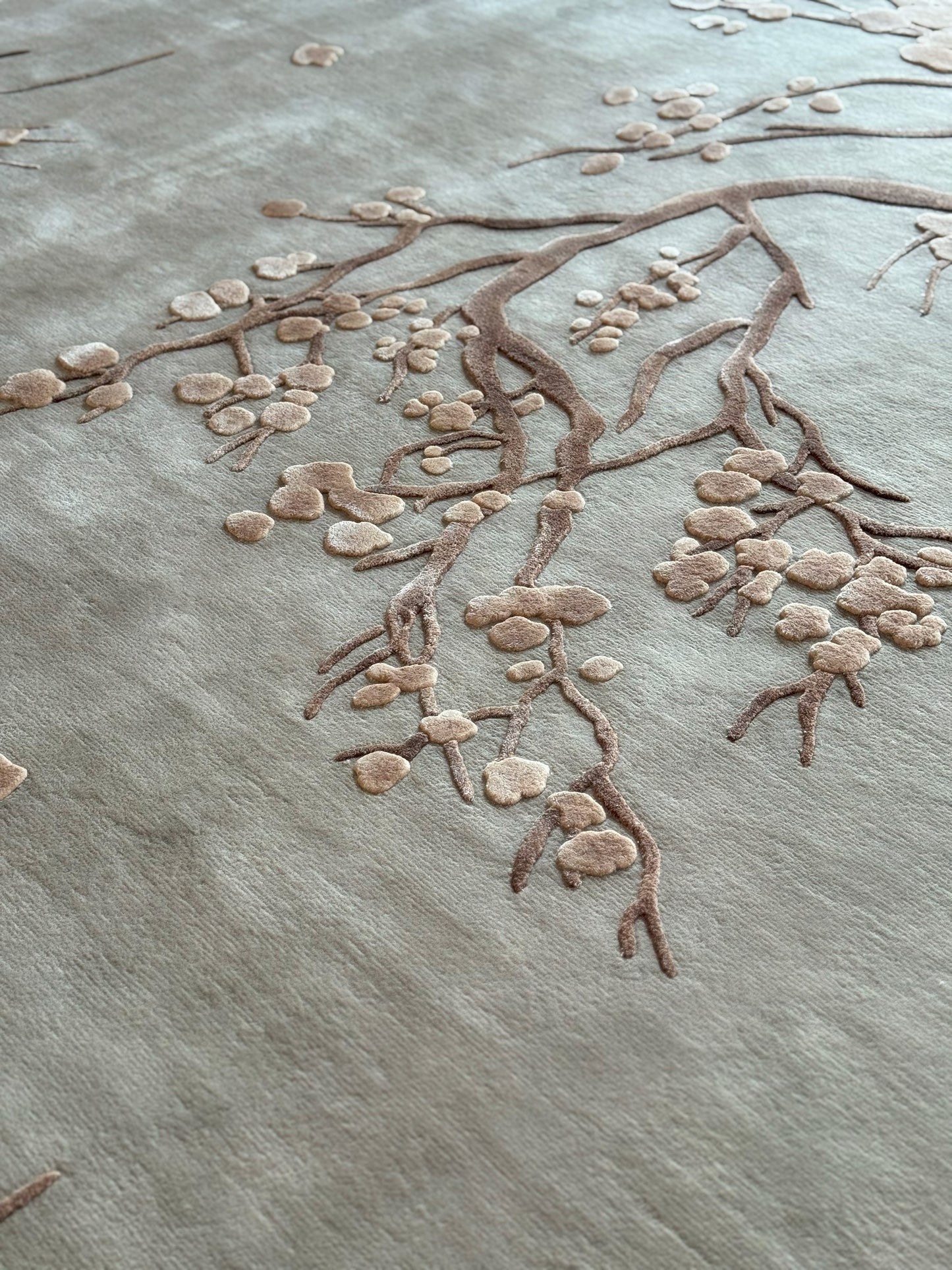 Textured surface with a branch and leaf design