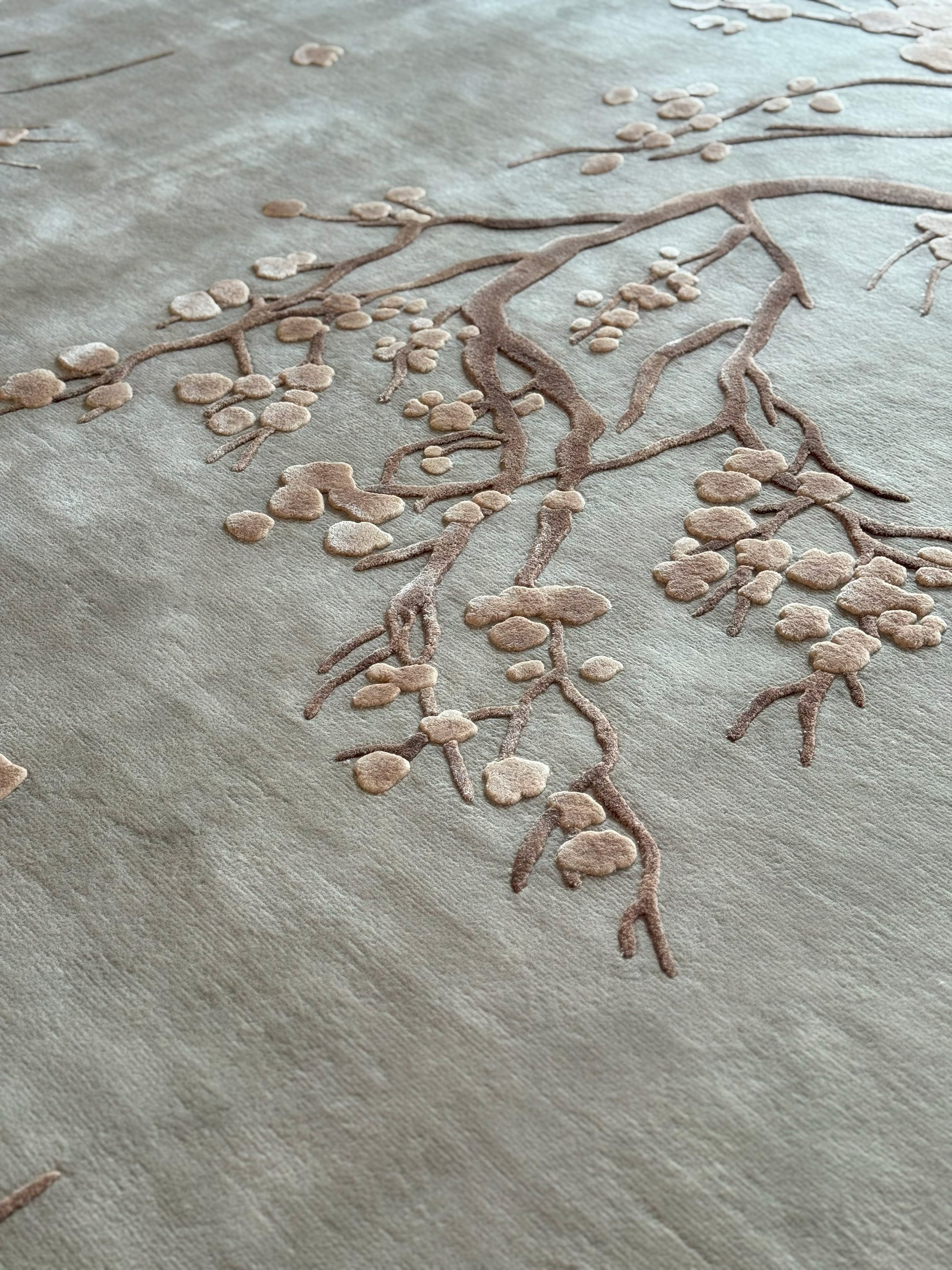 Textured surface with a branch and leaf design