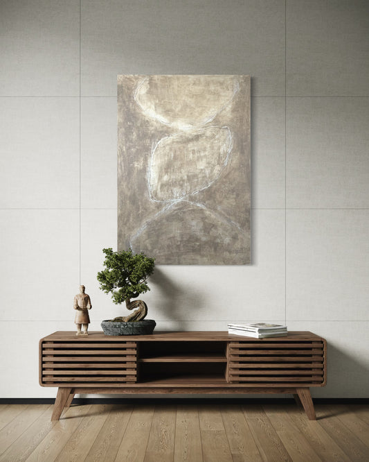 Wooden console table with decorative items against a gray wall with a painting.