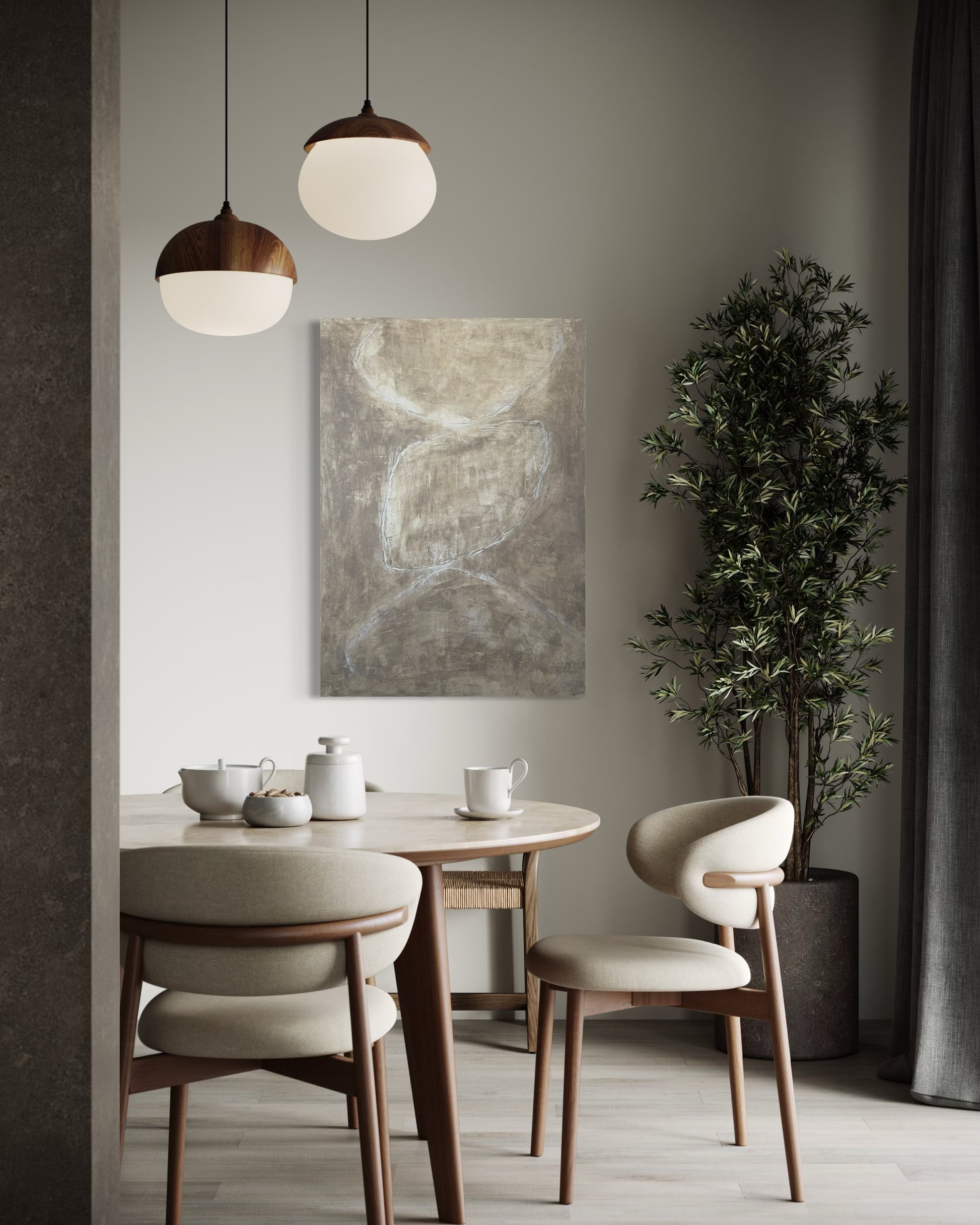 Dining room with a round table, chairs, and abstract art on the wall.