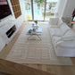 Modern living room with a white sofa, coffee table, and decorative items.
