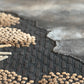 Textured black and brown rug with geometric pattern