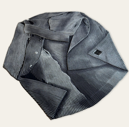 Folded gray pleated shirt on a white background