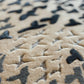 Close-up of a camouflage-patterned rug with black and beige colors.