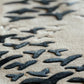 Close-up of textured fabric with black pattern on beige background