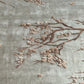 Close-up of embroidered floral design on fabric with a soft green background