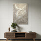 Wooden console table with decorative items against a gray wall with a painting.