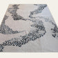 Rug with abstract black pattern on a white background